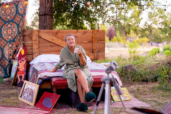 Lauren Letherer lounges on her bed as artist June, in THIS Theatre Co's production of ALABASTER by Audrey Cefaly. Photo by HyunJu Blemel.