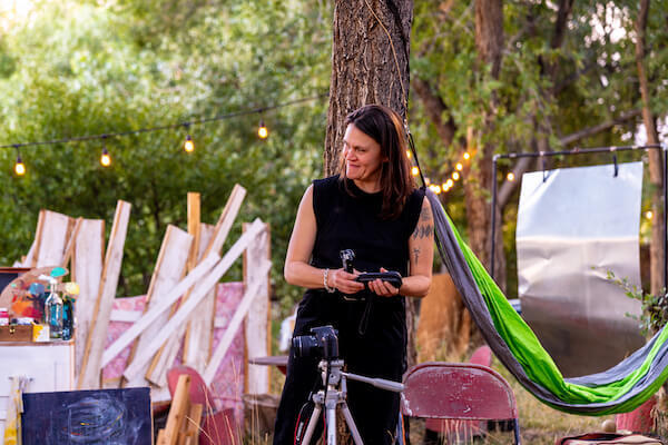 Alxis Scott* prepares her photography equipment, in THIS Theatre Co's production of ALABASTER by Audrey Cefaly. Photo by HyunJu Blemel.