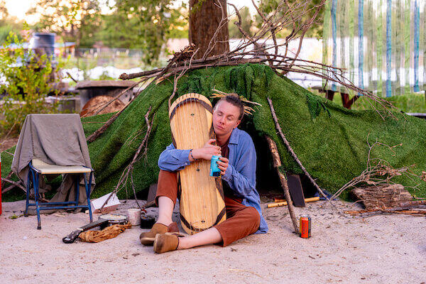 Bib (Rhiannon Frazier) clutches an instrument. ALABASTER by Audrey Cefaly, produced by THIS Theatre Co. Photo by HyunJu Blemel